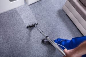 Technician removing water from carpet.